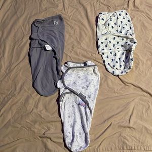 Two swaddle me swaddles (sm/md) and on nature swaddle (0-3)